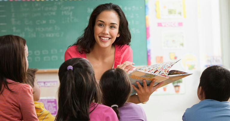 Parapro working with child in wheelchair in classroom