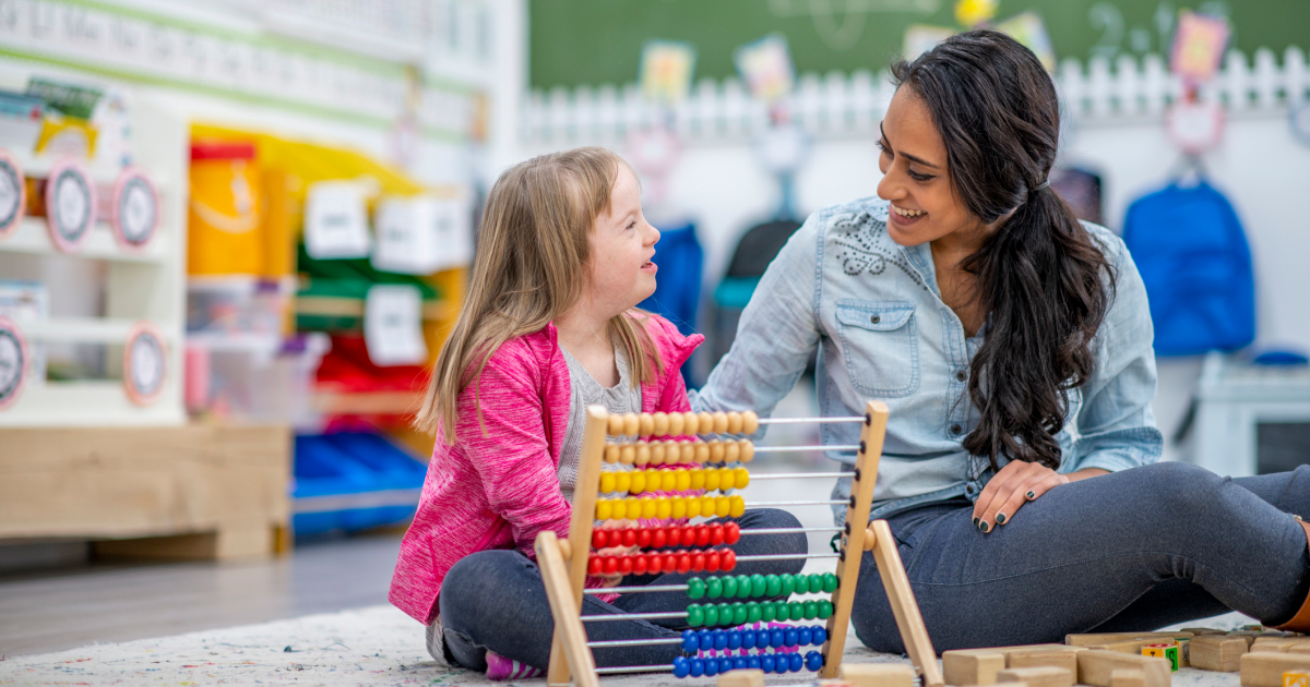 Paraeducator in a classroom with a young child